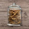 Dehydrated chicken feet from Buffalo Freeze Dry, displayed in a clear package, showcasing their crispy texture.