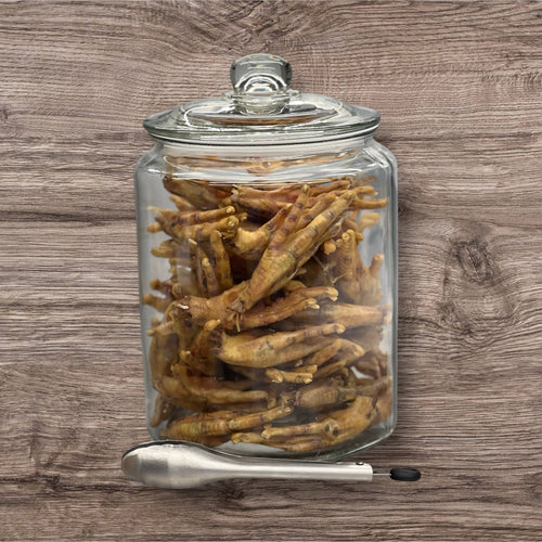 Dehydrated chicken feet from Buffalo Freeze Dry, displayed in a clear package, showcasing their crispy texture.